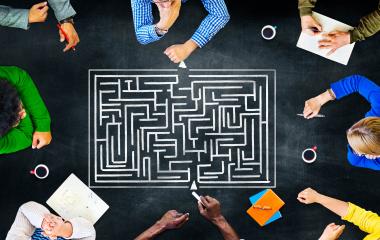 People trying to solve a labyrinth puzzle