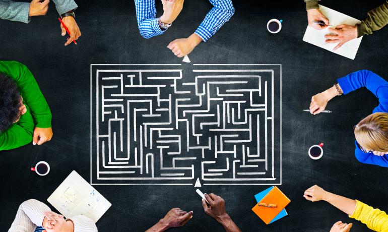 People trying to solve a labyrinth puzzle